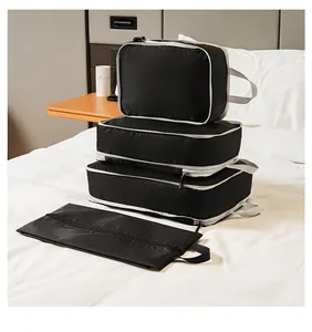 Macro detail of black travel organizer set with ripstop texture on white bedding