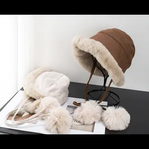Thick plush winter bucket hats for women with soft faux fur lining and pompom ties