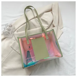 Close-up of holographic laser tote bag with light green leather handles on a suit jacket
