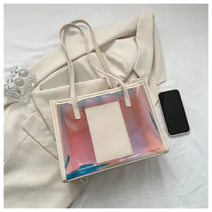 Detailed macro view of iridescent PVC tote bag with cream leather trim and handles
