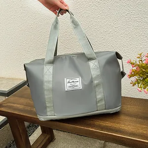Detail of light grey travel bag with waterproof texture and expandable zipper base