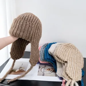 Close-up of knit ear protection hat showing thick textured yarn and colorful options