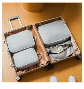 Waterproof nylon travel organizer set neatly arranged in a silver suitcase
