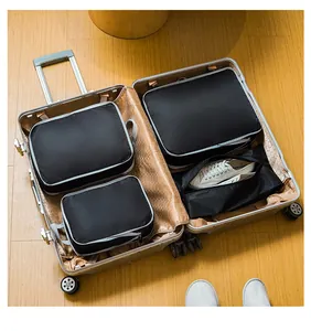 Detailed view of black compression travel organizers inside a premium suitcase