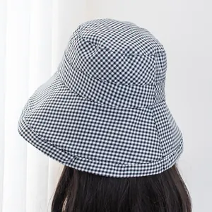 Classic black and white houndstooth bucket hat for women with wide sun protective brim