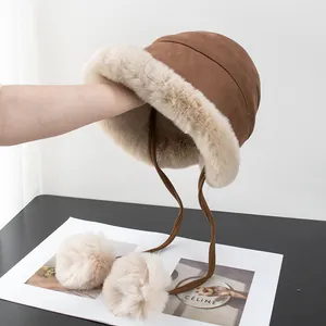Detailed view of winter plush earflap hat with faux fur lining and soft pompom ties