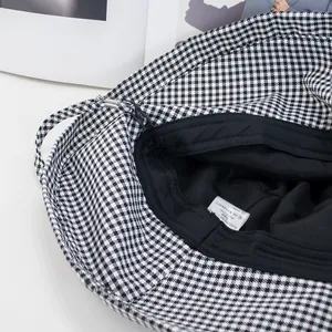 Detail showing the inner black lining and wash care label of this houndstooth bucket hat