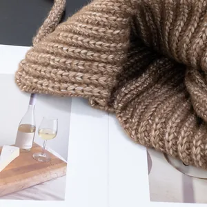 Women's warm camel knit earflap hat featuring thick ribbed wool and soft texture
