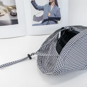 Classic black and white houndstooth bucket hat with wide brim and adjustable drawstring