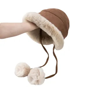 Winter plush bucket hat in brown faux suede with warm fleece lining and fluffy pom-poms