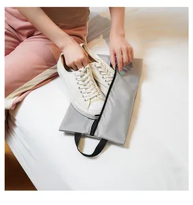 Detailed view of grey waterproof nylon shoe bag with zipper for travel luggage storage