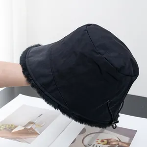 Detail view of the adjustable elastic drawstring and metal buckle on a black winter bucket hat