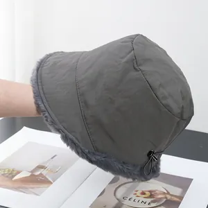 Detail of grey winter bucket hat featuring plush faux fur lining and adjustable drawstring