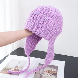 Detailed texture of purple chunky knit trapper hat with soft mohair earmuff straps