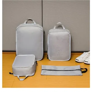Silver-grey 4-piece compression travel organizer set with mesh fabric and zipper closures
