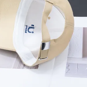 Unisex beige cotton baseball cap featuring embroidered HOPE logo and adjustable metal buckle