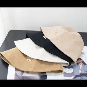 Minimalist cotton linen bucket hats in four colors with textured weave and side labels