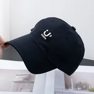 Detailed close-up of embroidered white HOPE letter and smiley logo on black cotton baseball cap