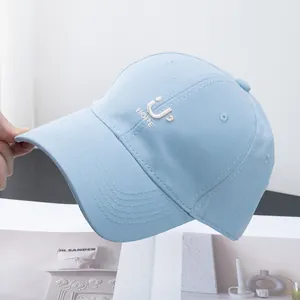 Close-up of embroidered 'U HOPE' lettering on a light blue cotton baseball cap