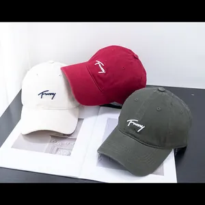 Detail of three cotton baseball caps in white, red and green with Funny embroidery