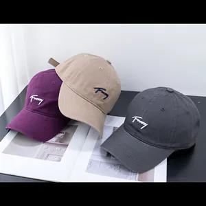 Detailed embroidery of 'Funny' text on purple, khaki, and dark grey cotton baseball caps