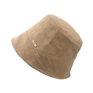 Breathable khaki cotton-linen bucket hat with textured waffle pattern and side logo label