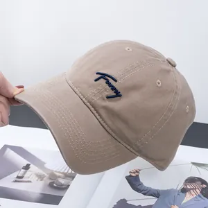 Detail of khaki cotton baseball cap showing Fanny embroidery and reinforced brim