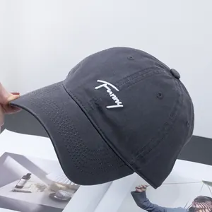 Close-up of Funny embroidery on dark gray cotton baseball cap with twill fabric texture