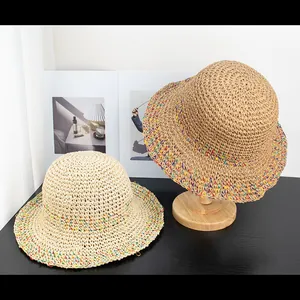 Hollow crochet straw sun hat with colorful rainbow trim and wide brim for beach vacation