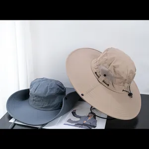 Detail view of khaki and grey outdoor hats with breathable mesh and chin strap