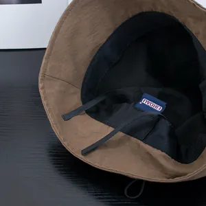 Japanese style brown sun bucket hat with adjustable windproof cord and black lining