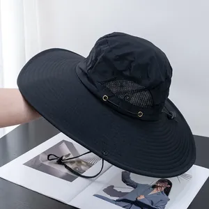 Detail view of the black wide brim sun hat showing side breathable mesh and metal eyelets