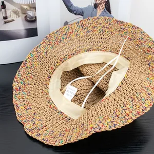 Close-up of woven paper straw hat with inner sweatband and adjustable drawstring feature