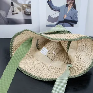 Beige straw sun hat with green plaid straps for summer beach vacation sun protection
