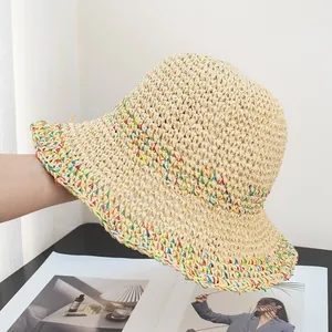 Close-up of beige crochet sun hat featuring colorful woven details and soft texture