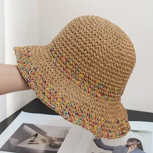 Detailed view of hollow crochet straw hat with colorful woven texture on the wide brim