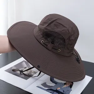 Detail of dark brown sun hat featuring breathable mesh vents and adjustable chin strap