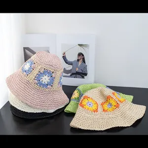 Detailed close-up of handmade crochet bucket hats with colorful knit sunflower patterns