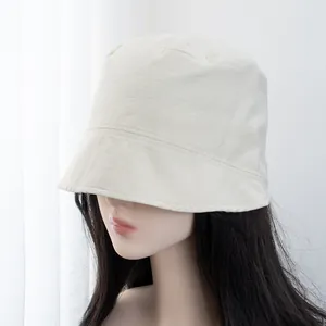 Detail of minimalist beige bucket hat featuring neat single-stitch craftsmanship edges