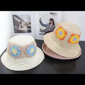 Foldable handmade crochet straw hat with bright floral pattern for beach sun protection