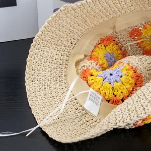 Foldable crochet straw hat for women featuring vibrant floral lining and 100% paper material