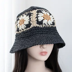 Close-up of hand-crocheted bucket hat featuring intricate daisy flower knit patterns