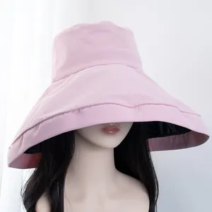 Detail of pink wide brim sun hat showing the black UV protective inner lining