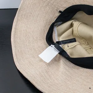 Detail view of wide brim sun hat showing inner sweatband, cotton lining and adjustable strap