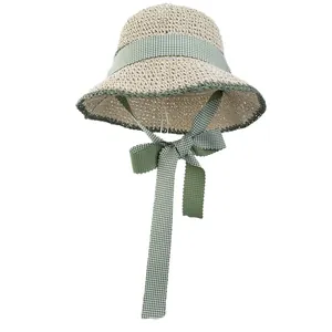 Japanese style woven straw sun hat with green plaid ribbon and bow for summer beach travel