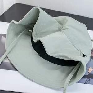 Detail view of light green wide brim sun hat showing contrast stitching and black inner lining