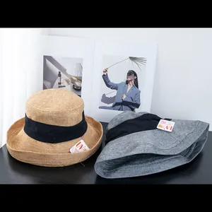 Detail of khaki and grey woven sun hats showing breathable texture and UV protective tags