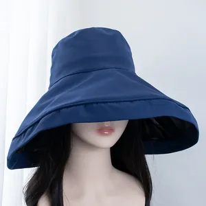 Detail view of large navy bucket hat with sun-protective black coating inside