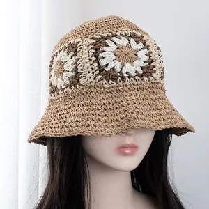 Close-up of hand-woven straw bucket hat with floral pattern and breathable texture