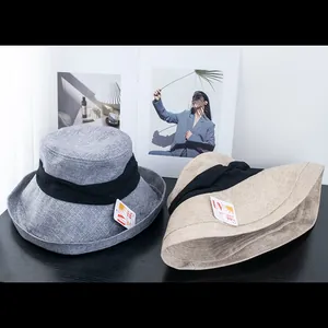 Detail view of beige and grey UV protection bucket hats with premium textile texture